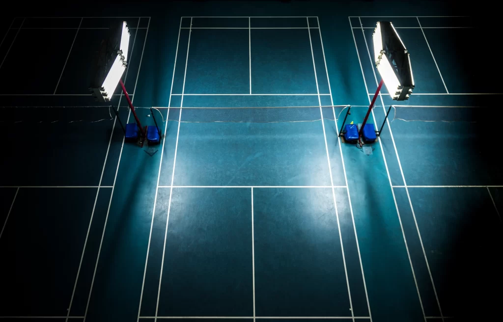 indoor-badminton-court-with-bright-white-lights-scaled.webp