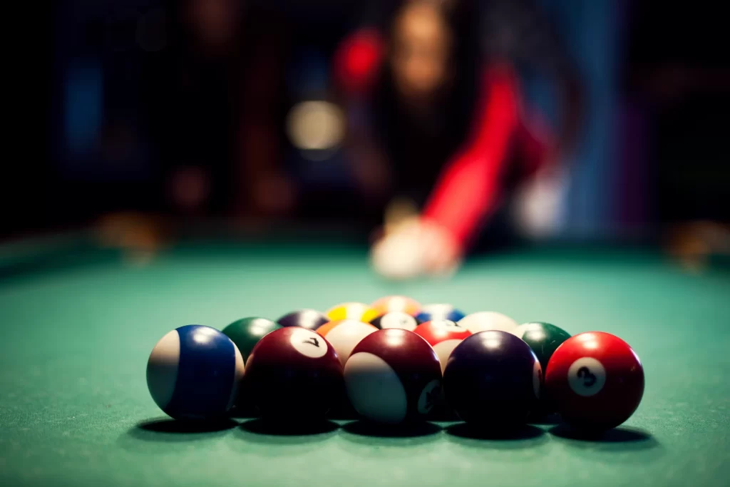 young-woman-playing-billiard-scaled.webp